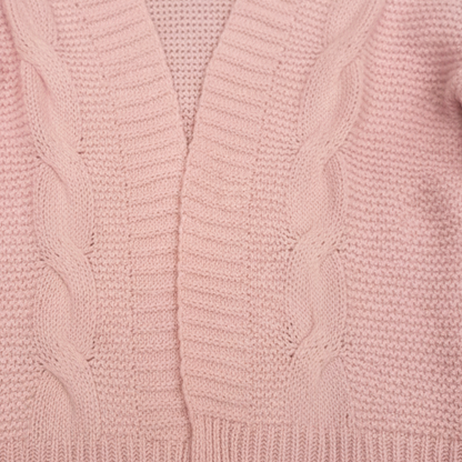 Close-up of a pink cable knit sweater