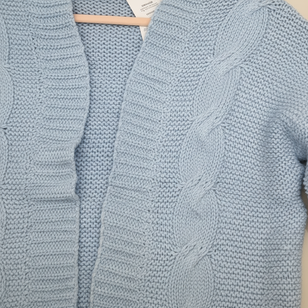 blue knitted cardigan on a beige background