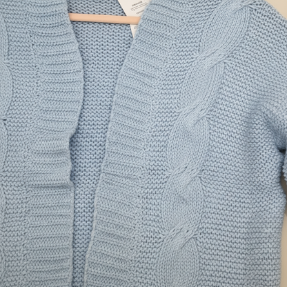 blue knitted cardigan on a beige background