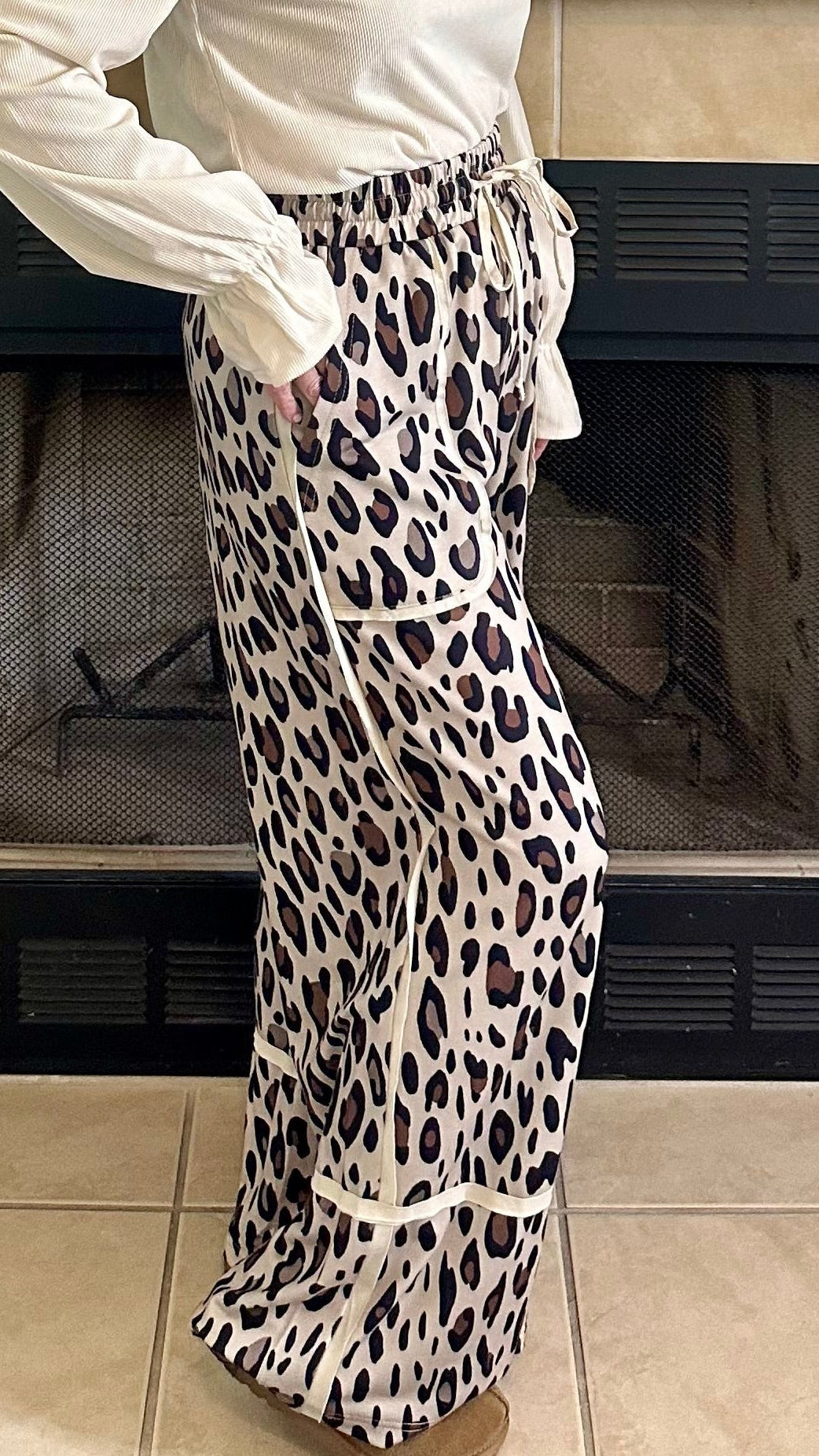 Woman standing in a living room with a decorated fireplace