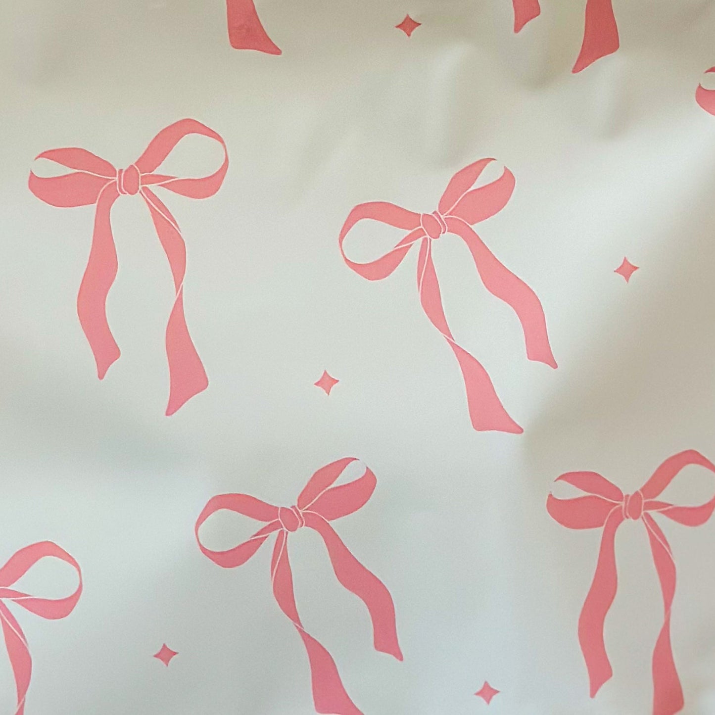 White and pink package with pink bows