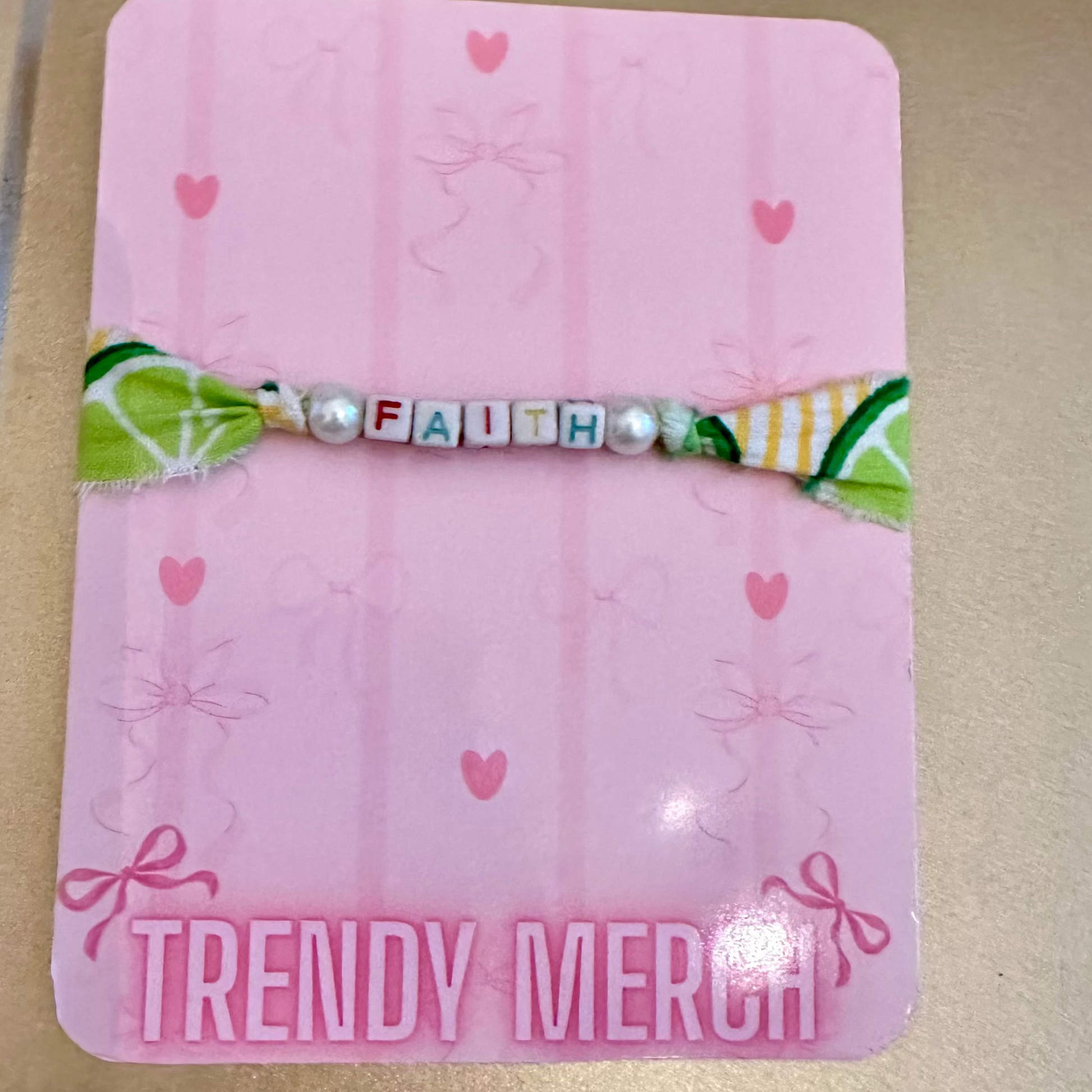 Pink card with decorative elements and 'TRENDY MERCH' branding on a beige background