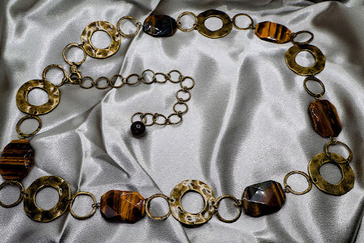  A unique belt  that combines metal chains with natural stones. Measuring 46 inches in length, this belt features a secure lobster claw closure for a comfortable fit. 