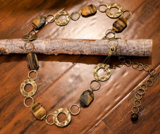 Brass and stone belt on a wooden surface