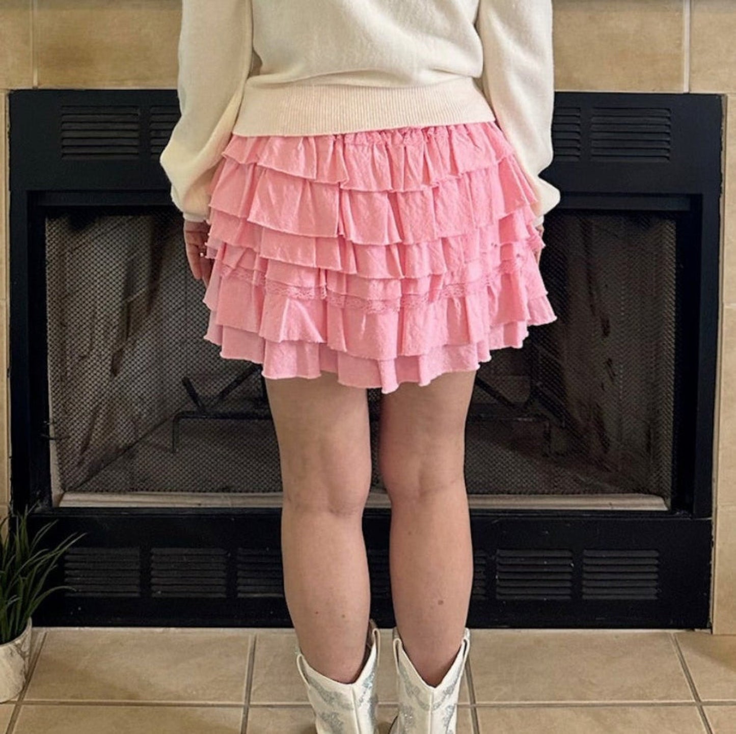 Pink Tiered Ruffle Mini Skirt is the epitome of feminine charm and playful style. Featuring an elastic waistband for a secure and adjustable fit.