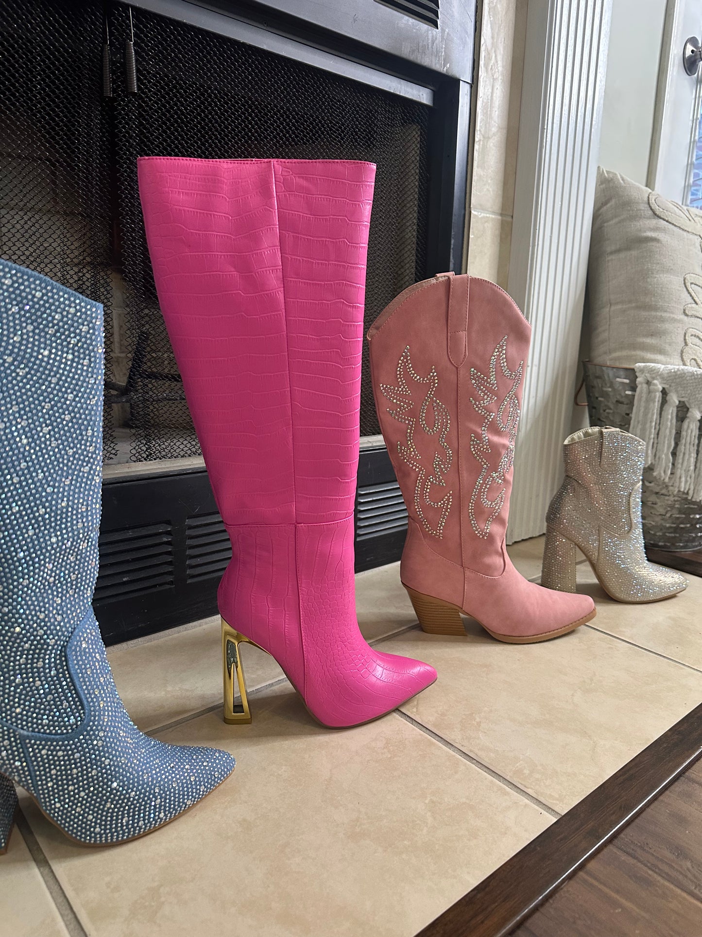  Croc Knee-High Boots are a bold statement piece designed to elevate any outfit. Featuring an eye-catching croc-embossed texture and a vibrant pink hue.