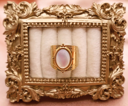  Ring is a masterpiece of feminine elegance and celestial charm. Featuring a lustrous oval pearl-like centerpiece.