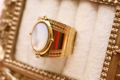 Ring is a masterpiece of feminine elegance and celestial charm. Featuring a lustrous oval pearl-like centerpiece.