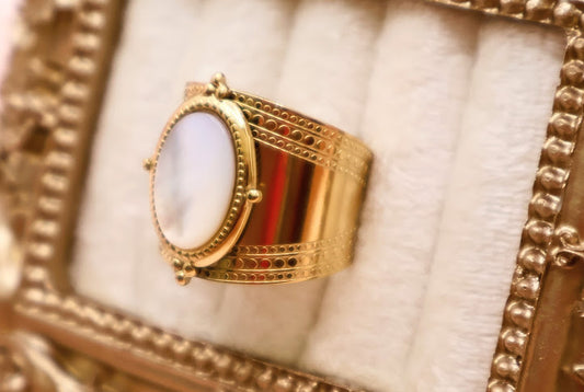 Ring is a masterpiece of feminine elegance and celestial charm. Featuring a lustrous oval pearl-like centerpiece.