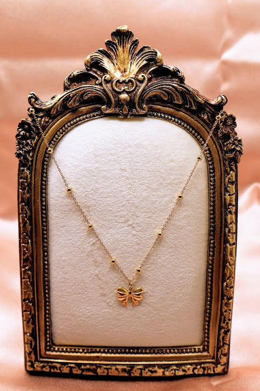  Bow Charm Necklace on dainty gold chain with smal gold beads. 