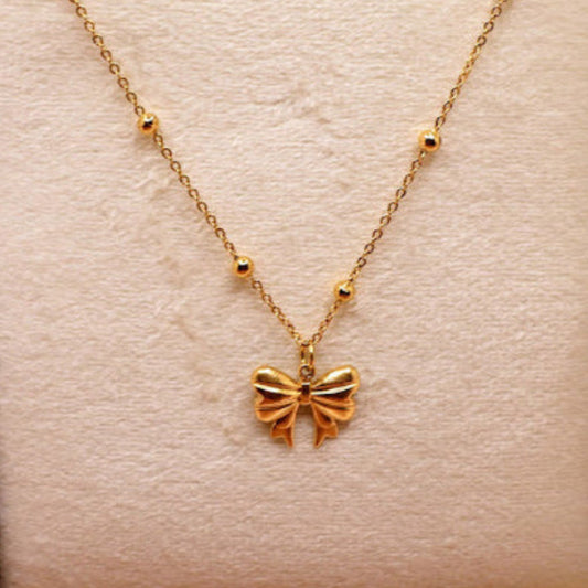  Bow Charm Necklace on dainty gold chain with smal gold beads. 