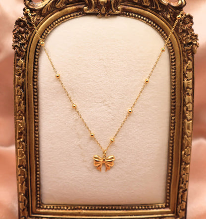  Bow Charm Necklace on dainty gold chain with smal gold beads. 