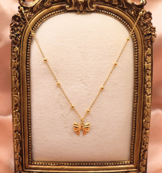  Bow Charm Necklace on dainty gold chain with smal gold beads. 