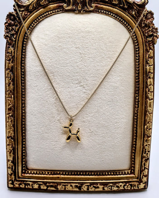  Balloon Dog Charm Necklace is a playful and quirky accessory designed to bring a smile to your face. Featuring a dainty gold-tone balloon animal pendant, this necklace is as fun as it is charming. 