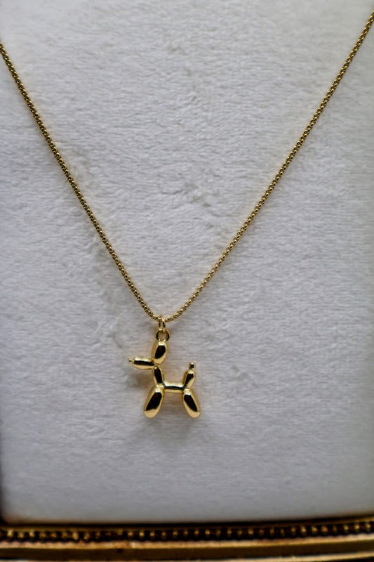  Balloon Dog Charm Necklace is a playful and quirky accessory designed to bring a smile to your face. Featuring a dainty gold-tone balloon animal pendant, this necklace is as fun as it is charming. 