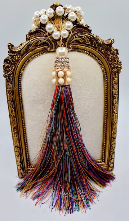 Pearl  tassel necklace features a vibrant multi-colored tassels that flow beautifully from a classic strand of elegant pearls. 