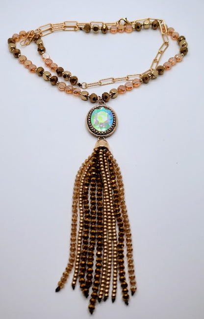 A necklace adorned with colorful details, beautifully framed by a mix of shimmering beads and a playful gold tassel.