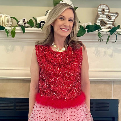 Sequin Feather Crop Top is a bold and glamorous statement piece. Featuring shimmering red sequins and a playful feathered hem.