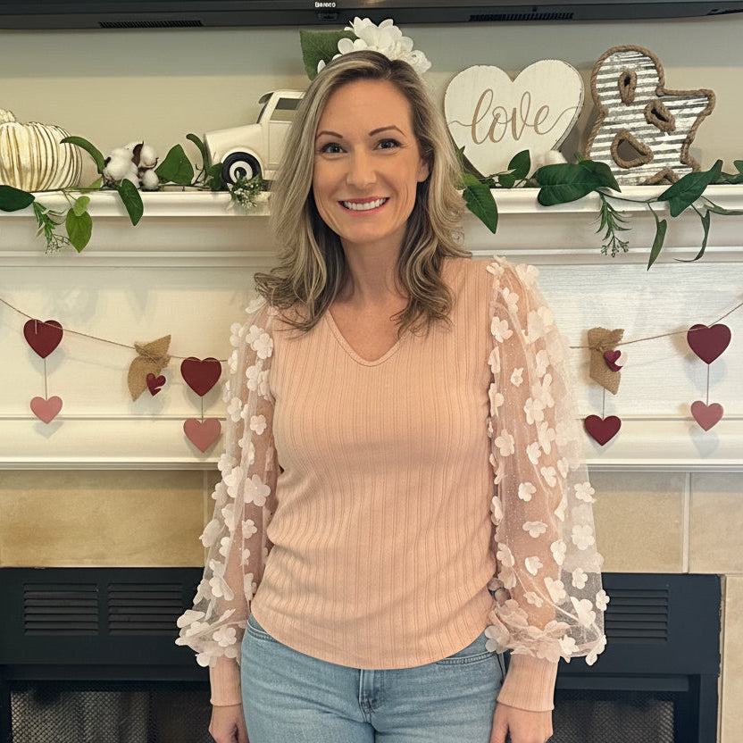 Floral Sleeve Top brings a touch of elegance and charm to your wardrobe. Designed with sheer puff sleeves adorned with 3D floral appliqués and a soft V-neckline.