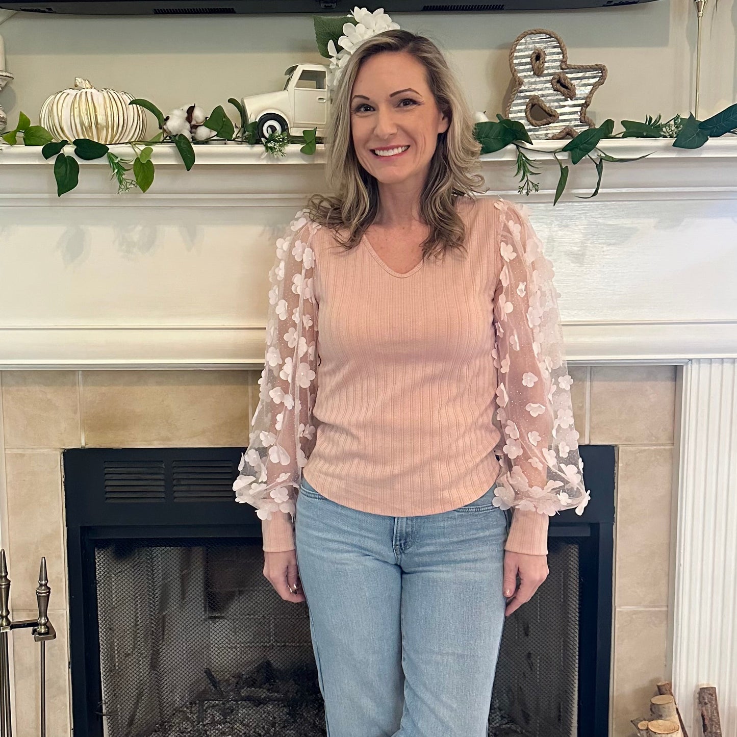 Floral Sleeve Top brings a touch of elegance and charm to your wardrobe. Designed with sheer puff sleeves adorned with 3D floral appliqués and a soft V-neckline.