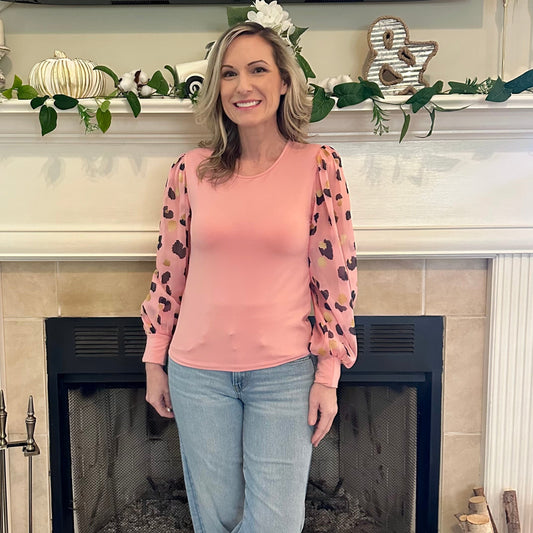 Pink Leopard Sleeve Top is a stylish blend of simplicity and boldness. Featuring sheer leopard-print puff sleeves and a sleek solid bodice.