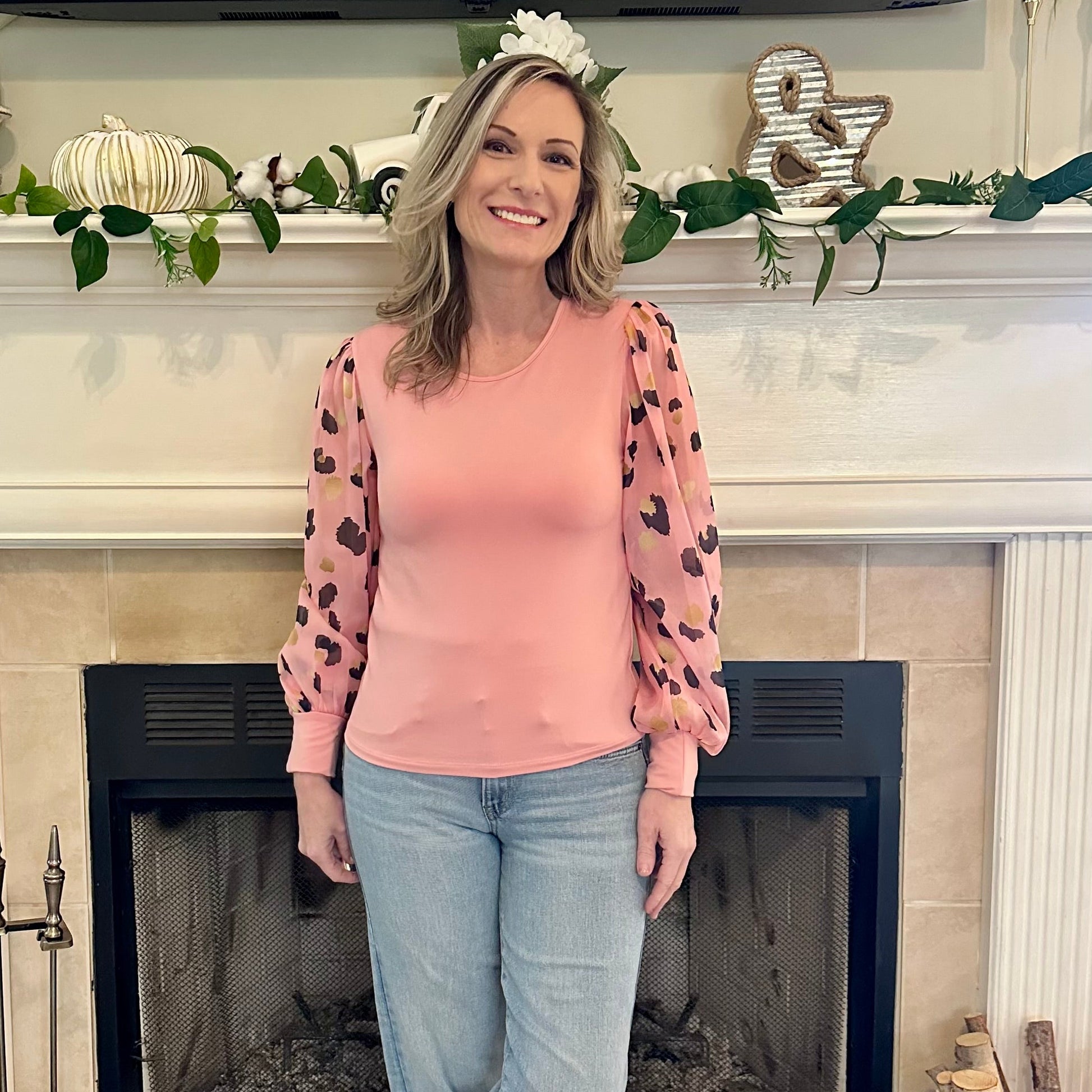 Pink Leopard Sleeve Top is a stylish blend of simplicity and boldness. Featuring sheer leopard-print puff sleeves and a sleek solid bodice.