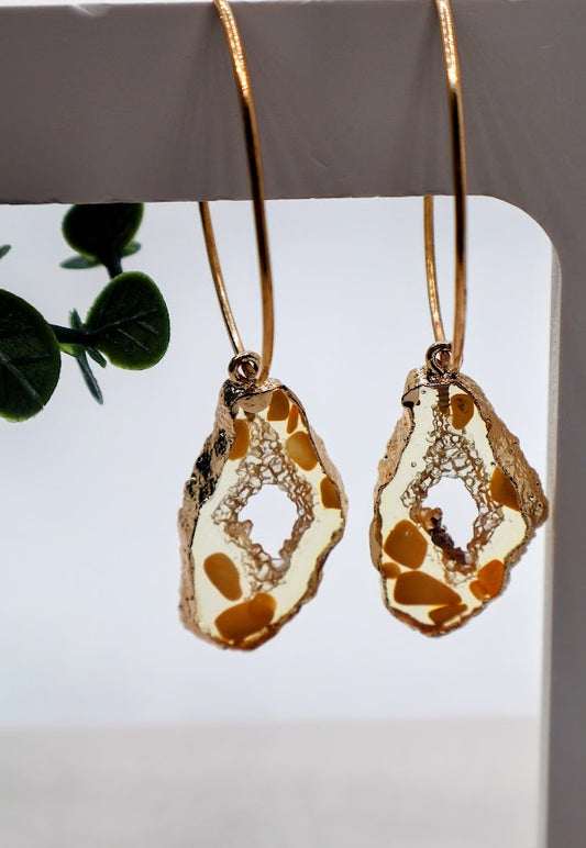 Gold and clear stone shaped earrings with gold flecks incorporated inside. 