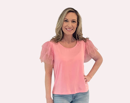 Pink Ruffle Sleeve Top is a fun and feminine piece that adds a playful touch to any outfit. Featuring delicate polka-dot mesh ruffle sleeves and a soft, lightweight fabric.