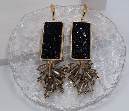 Black stone earrings feature bold, rectangular black stone accents and fanned beads. 