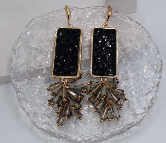 Black stone earrings feature bold, rectangular black stone accents and fanned beads. 