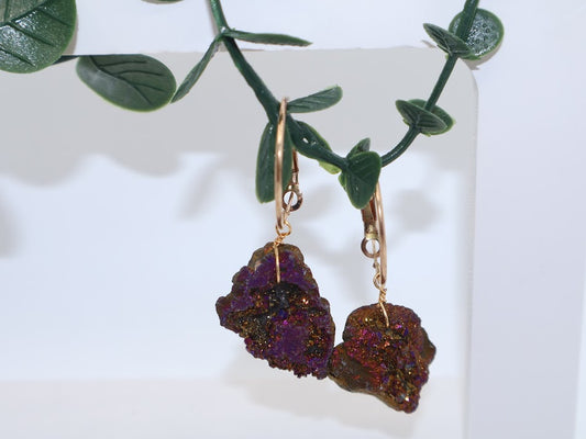 Pair of hoop earrings with purple and gold stone. 
