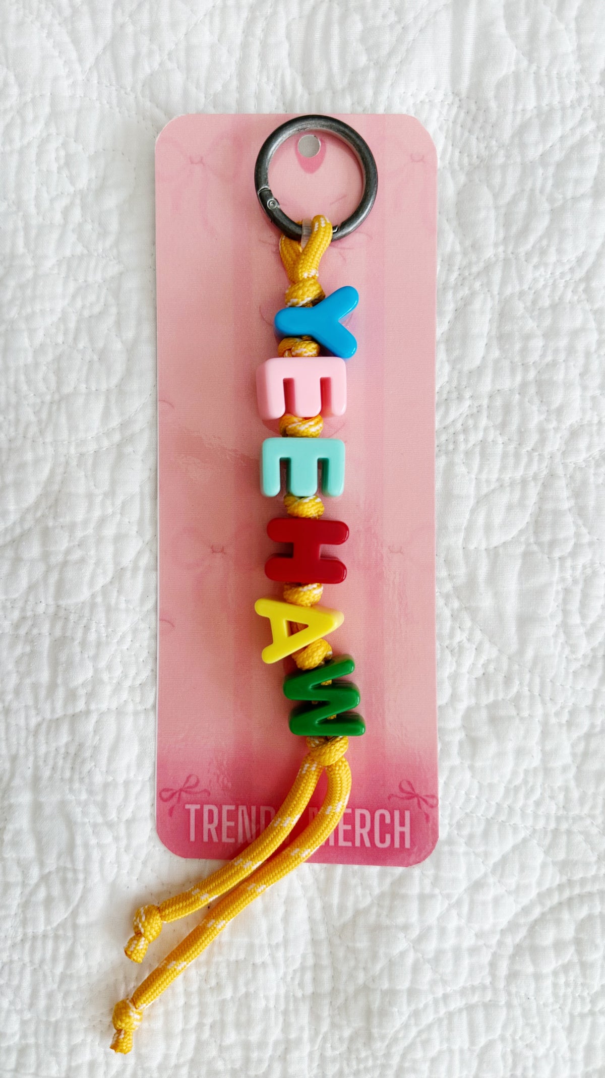 Yeehaw bag charm displayed on a pink Trendy Merch card