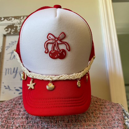 Red and white cap with embroidered design on a textured surface