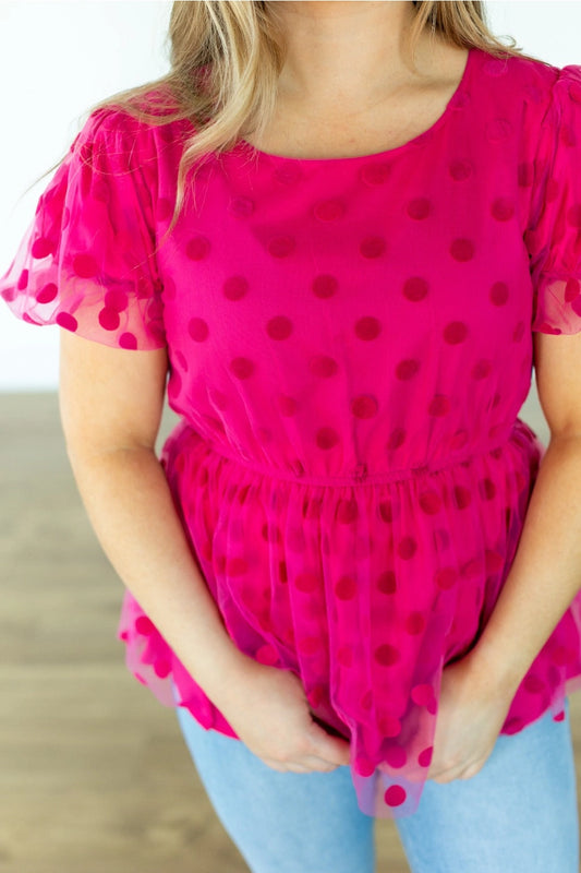  Polka Dot Peplum Blouse is a chic and versatile piece designed for effortless transitions from day to date night. Featuring a crew neck, flattering peplum silhouette, and an elastic waistband.