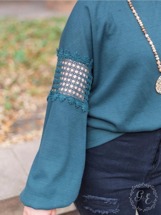 Teal Green Lace Accent Top is a perfect blend of comfort and style. Featuring delicate lace details on the sleeves and a relaxed fit.