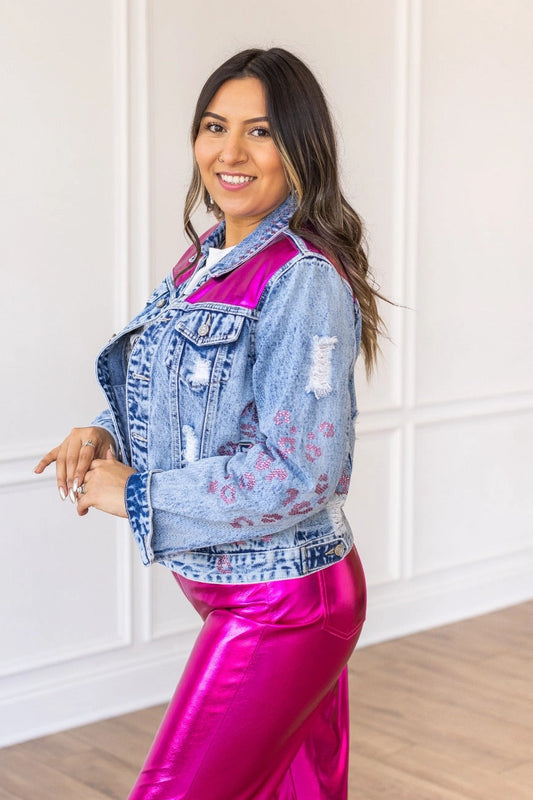  Denim Jacket is a striking blend of classic denim and glamorous details. Featuring a fitted silhouette, distressed touches, vibrant satin panels, and jeweled accents. 