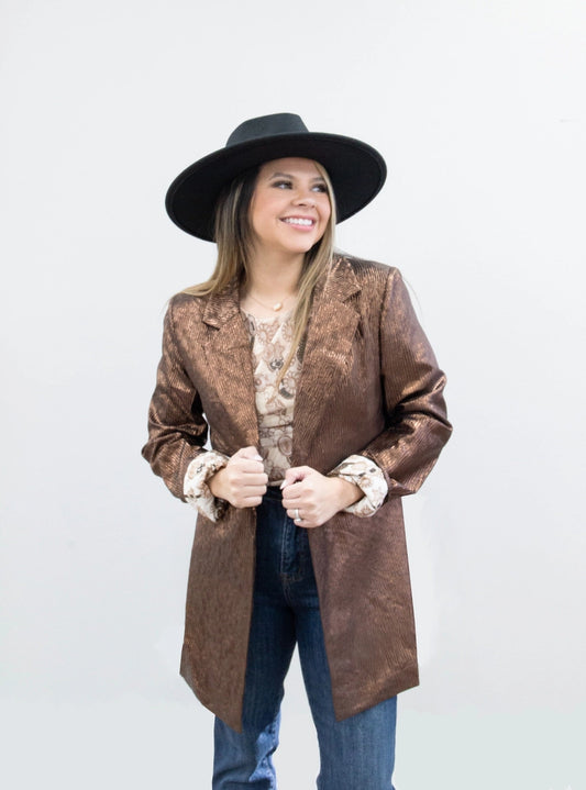 Metallic Blazer is a bold statement piece that effortlessly blends sophistication and glamour. Featuring a sleek metallic sheen, a lined interior, and functional pockets.