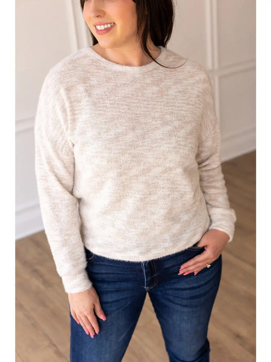  Cozy Knit Top is the ultimate blend of comfort and style. Made with a soft and breathable fabric blend, this top is perfect for everyday wear. Featuring a relaxed fit, long sleeves, and a subtle heathered texture.