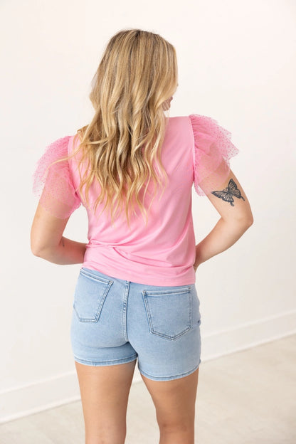 Pink Ruffle Sleeve Top is a fun and feminine piece that adds a playful touch to any outfit. Featuring delicate polka-dot mesh ruffle sleeves and a soft, lightweight fabric.