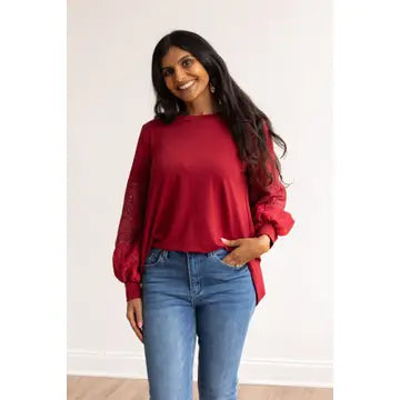 Eyelet Sleeve Top combines casual comfort with a touch of elegance. Designed with a relaxed fit, this top features intricate eyelet lace balloon sleeves.