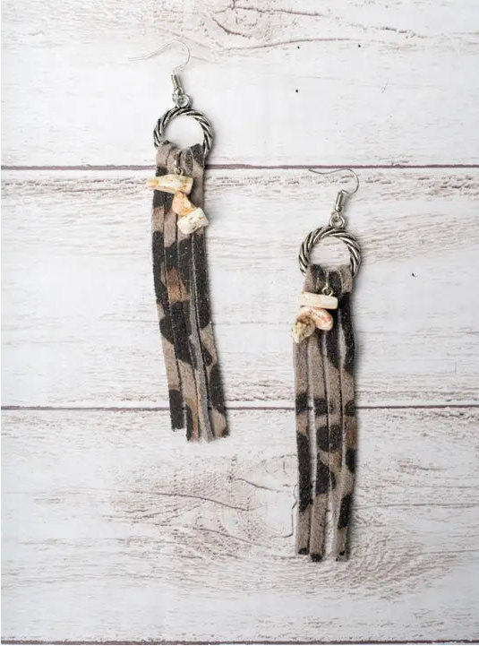Pair of tassel earrings on a wooden surface