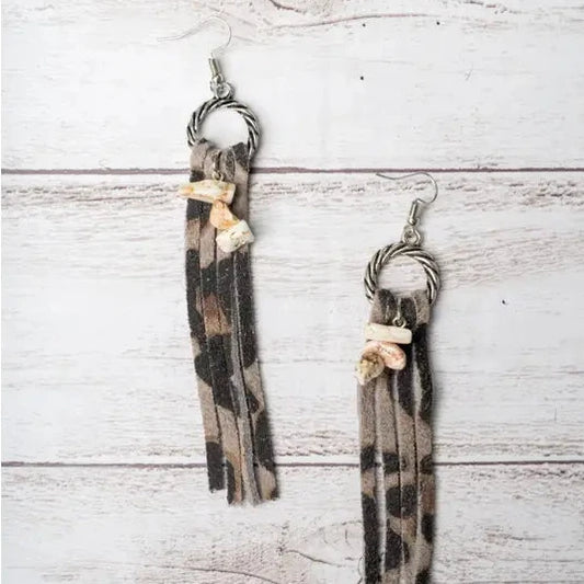Pair of tassel earrings on a wooden surface