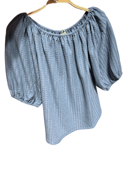 Textured Blouse. A gathered neckline, and airy three-quarter sleeves. 