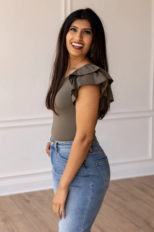 Olive Ruffle Sleeve Bodysuit combines elegance and practicality with its fitted design and charming ruffle sleeves.