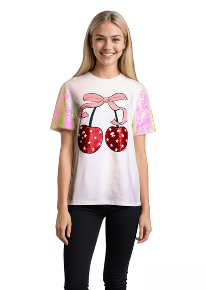 A white t-shirt with cherry design and pink sequin sleeves. 