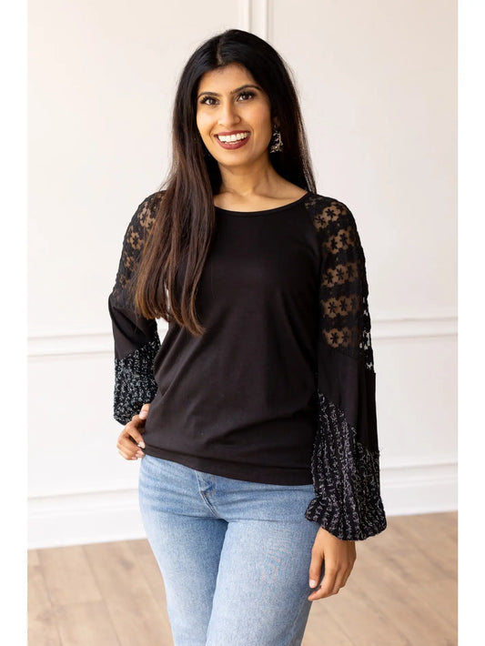  Lace Sleeve Top combines classic elegance with modern flair. This true-to-size top features intricate lace detailing on the sleeves and a softly flared cuff.