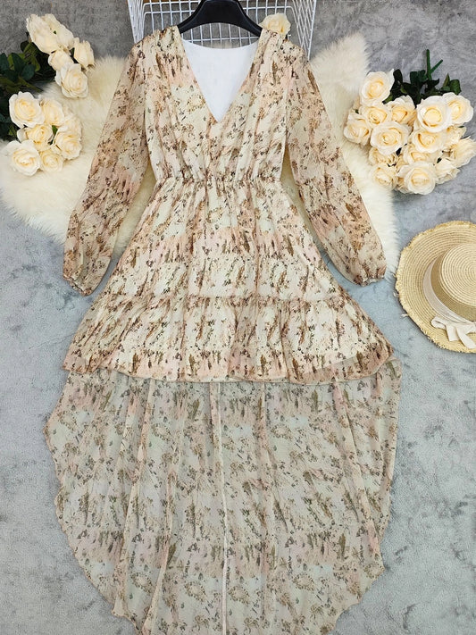 Cream Floral Ruffle Maxi Dress is a dreamy and romantic piece that exudes effortless elegance. Featuring a deep V-neckline and long, sheer sleeves.