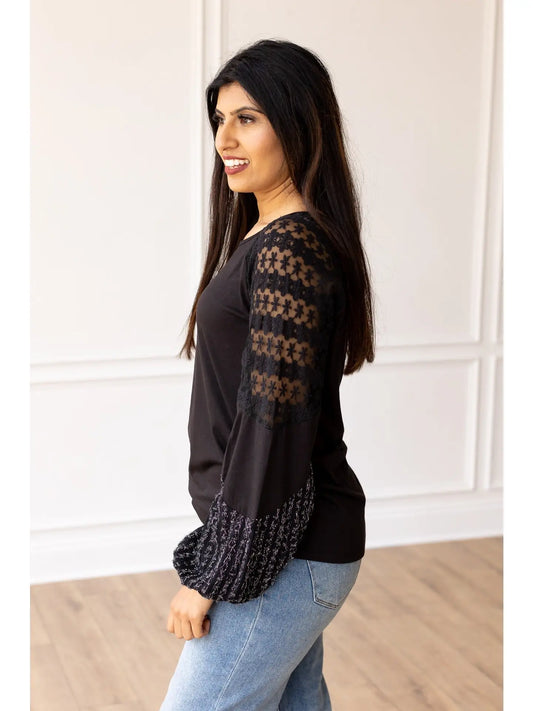  Lace Sleeve Top combines classic elegance with modern flair. This true-to-size top features intricate lace detailing on the sleeves and a softly flared cuff.