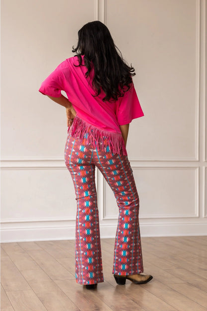 Aztec Flare Pants are a bold and stylish choice, designed to make a statement. These fitted pants feature a vibrant Aztec-inspired pattern and a flattering flared silhouette.