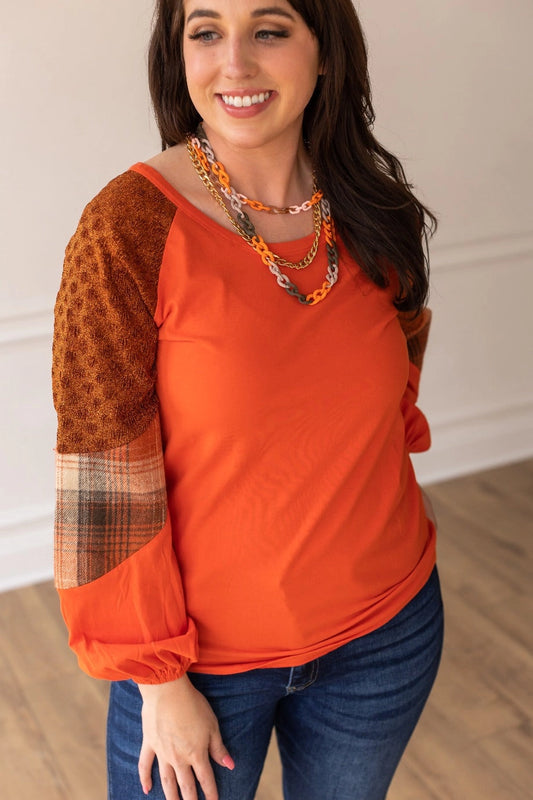 Rust/Orange Plaid Sleeve Crew Neck Top is a cozy and stylish piece that combines classic charm with modern details. Featuring a relaxed fit, semi-stretch fabric, and a comfortable crew neck.